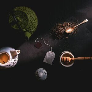 two teapots beside mortar and pestle